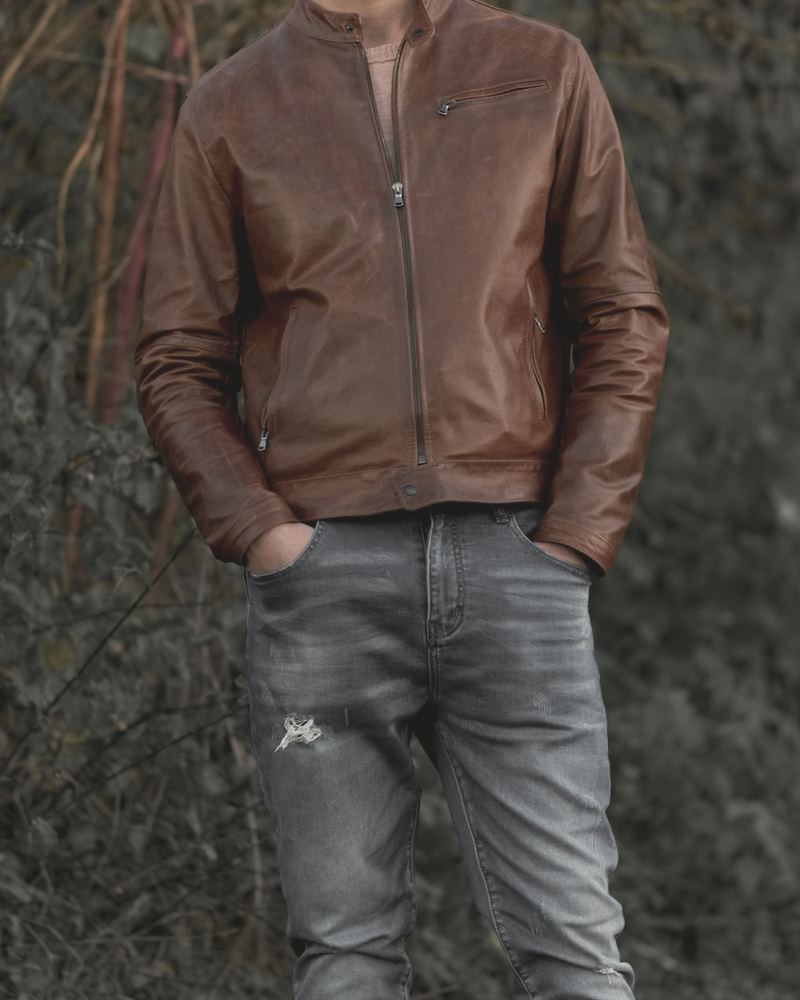 Chestnut brown stand-collar leather jacket worn with blue jeans
