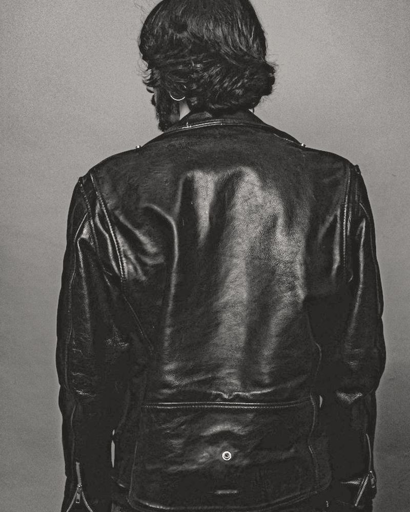 Back view of the jacket on a model, showing the belted back panel